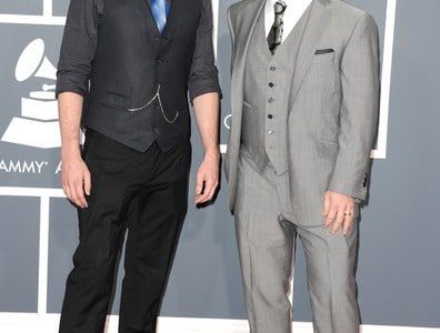 Two men in suits and ties standing next to each other.