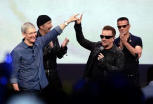 Apple CEO Tim Cook, left, greets Bono from the band U2 after they preformed at the end of the Apple event on Tuesday, Sept. 9, 2014, in Cupertino, Calif. Apple unveiled a new Apple Watch, the iPhone 6 and Apple Pay. (