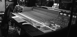 A large sound board in a recording studio.